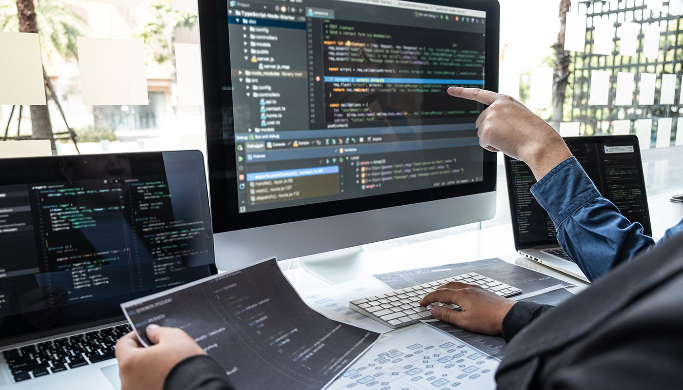 Modern Hamilton business owner reviewing a professional website design on a laptop.
